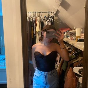 Black strapless corset top. Adjusting casp back